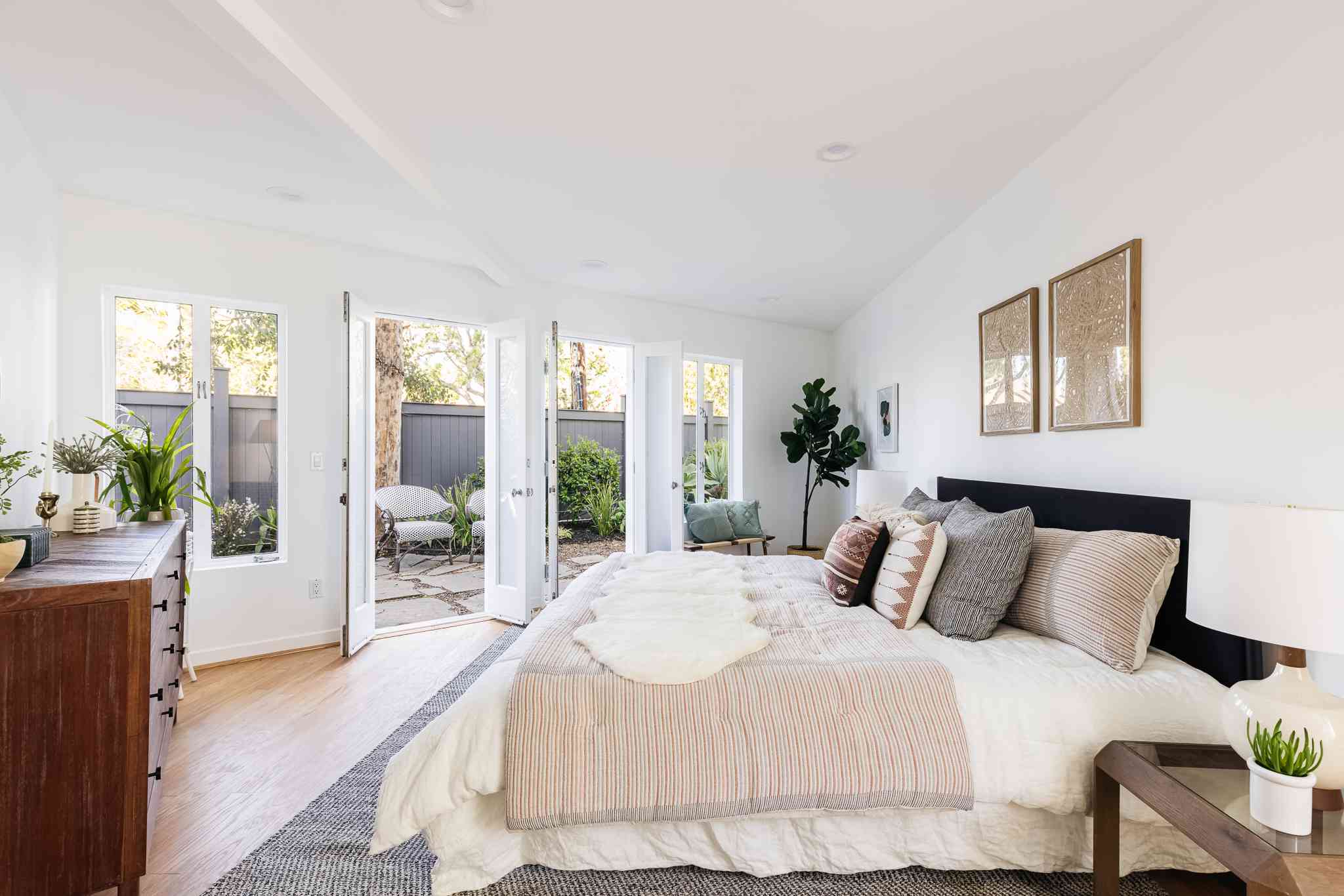 Bright white bedroom cleaned by Dazzle & Shine Maid Service in Orlando